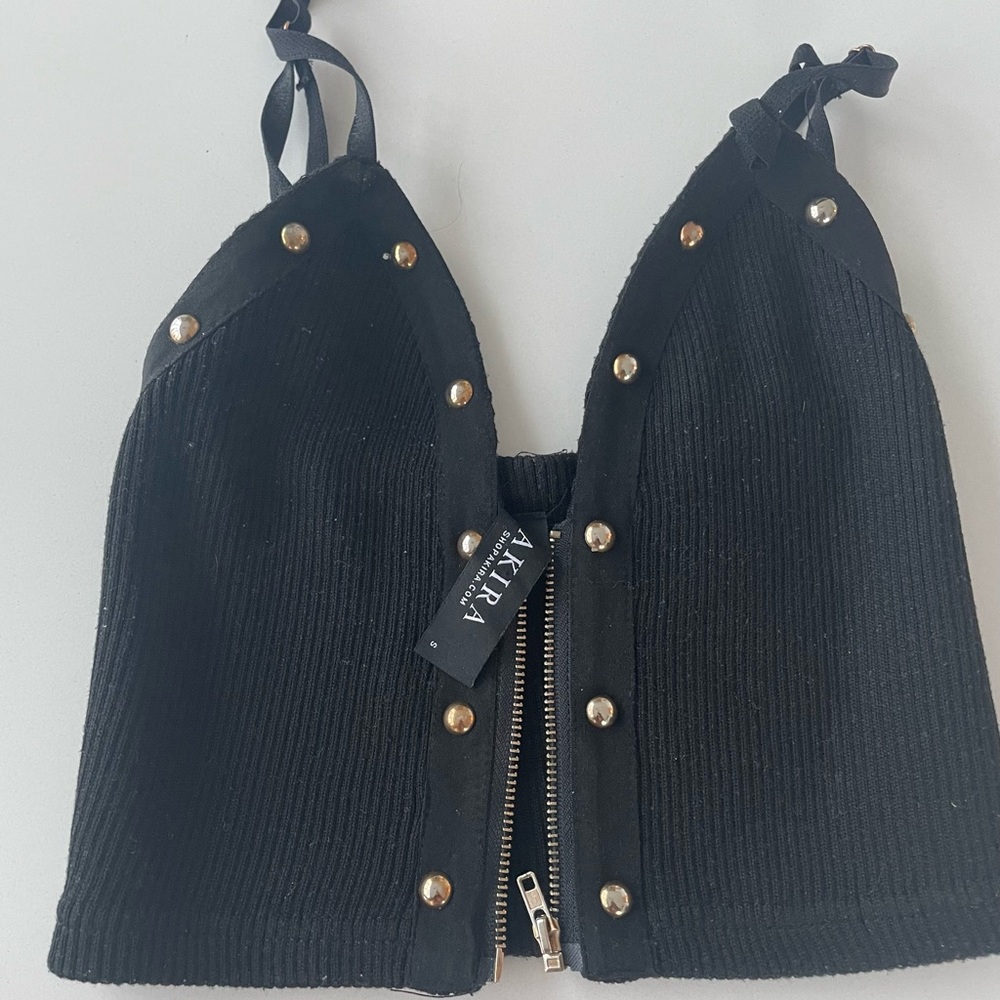 Black crop top tank with adjustable straps and zipper. Worn only a few times.